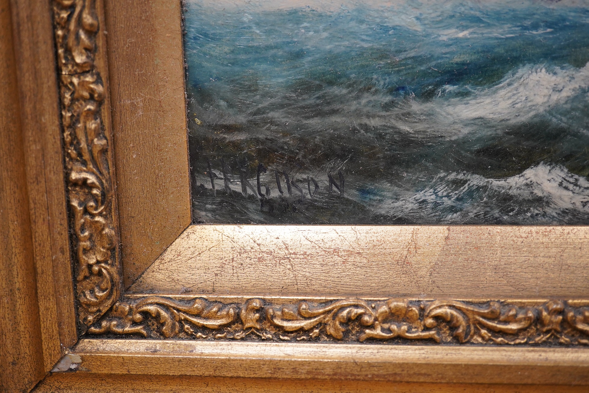 J. Ferguson, oil on board, Rocky seascape with boats, signed and indistinctly dated, 29 x 54cm, ornate gilt framed. Condition - fair to good